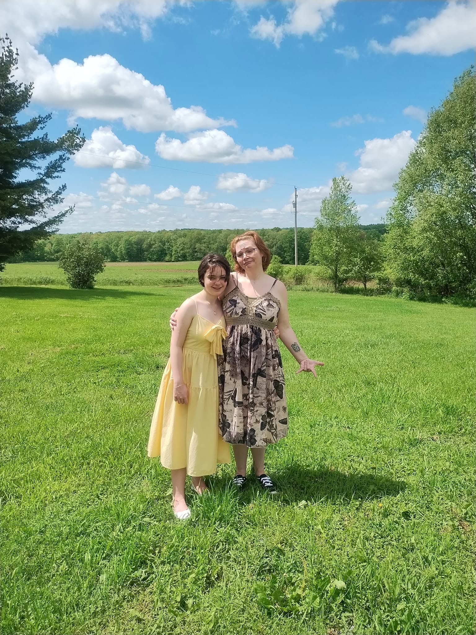 Two family members standing together in a field