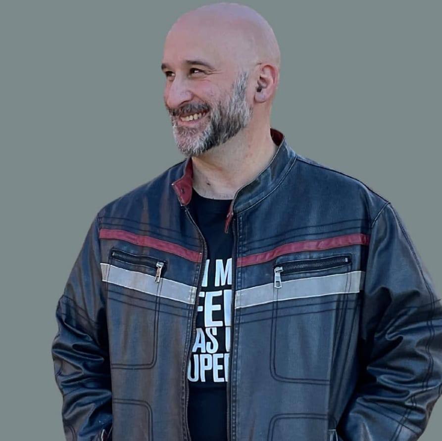 Johnathan Hales smiling in a leather jacket