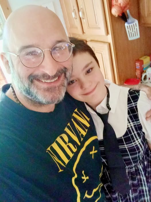 Johnathan Hales with a family member in a kitchen
