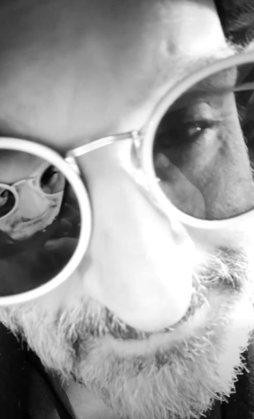 Black and white close-up of Johnathan Hales in sunglasses